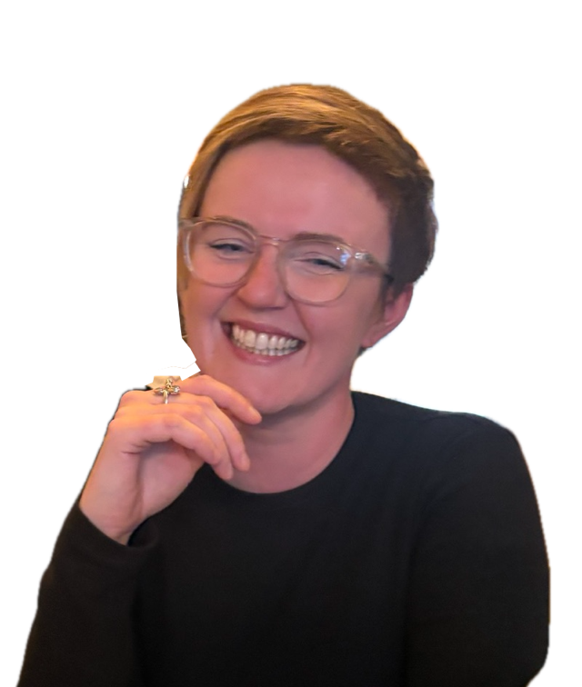 Kirstin, smiling, in clear-framed glasses